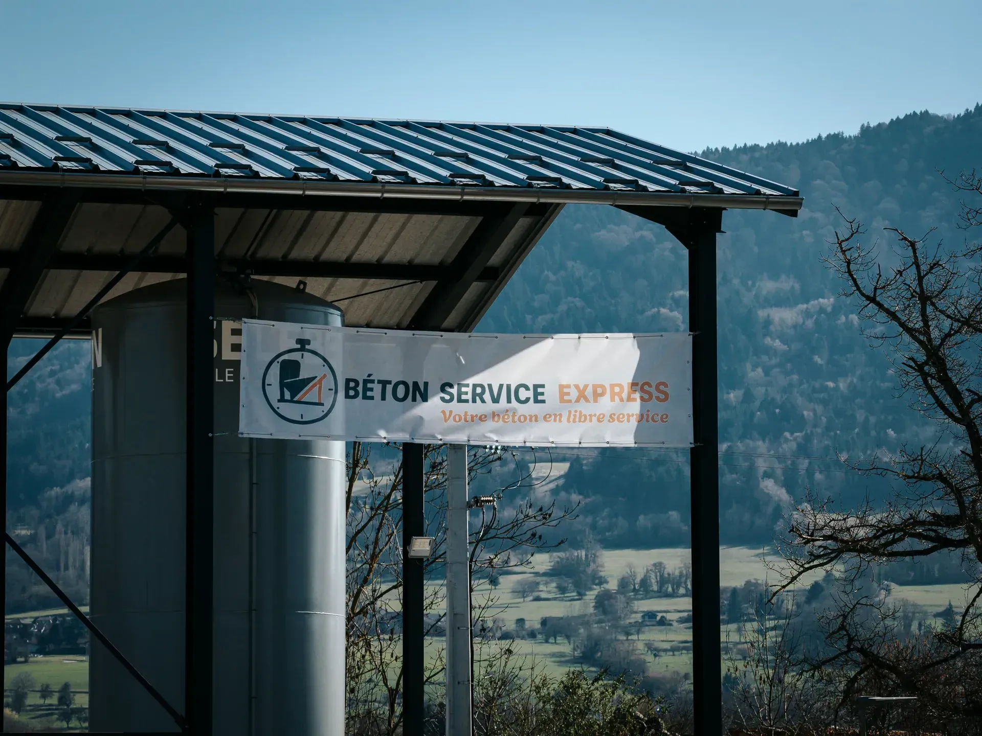 Panneau Béton Service Express devant l’abri du distributeur